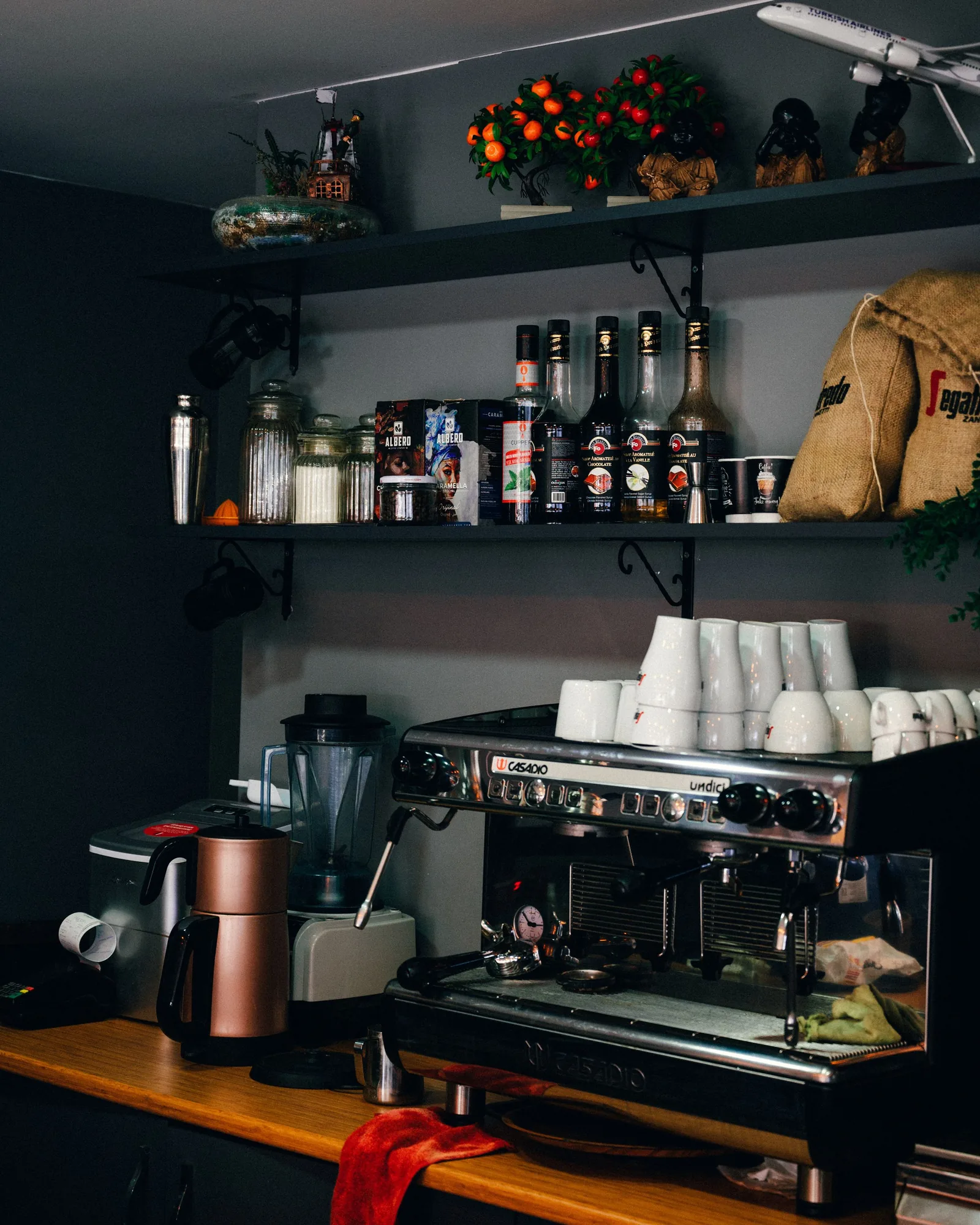 The counter with coffee bags on the shelf