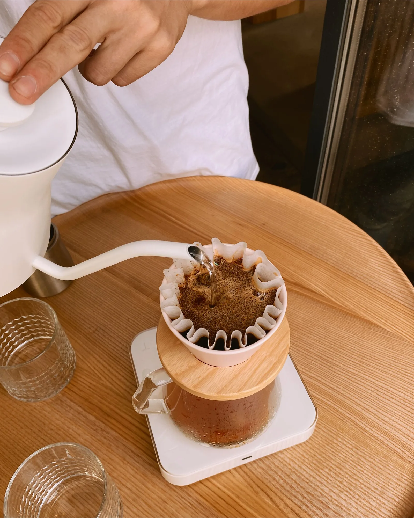 Hand pouring water over a coffee filter
