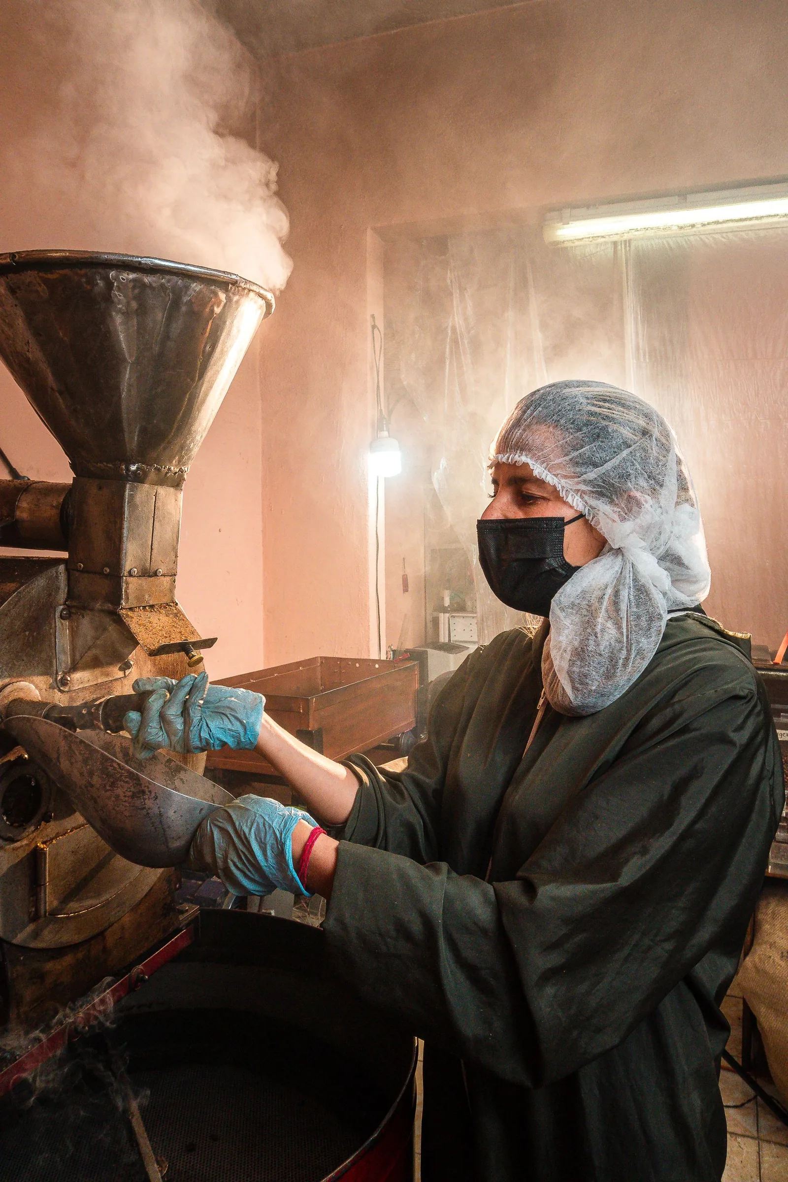 Roaster checking the beans at the drum